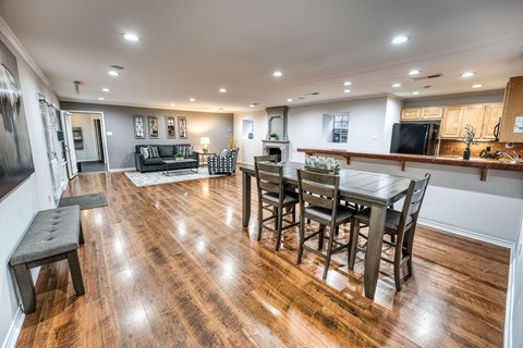 a living room and dining room with a table and chairs